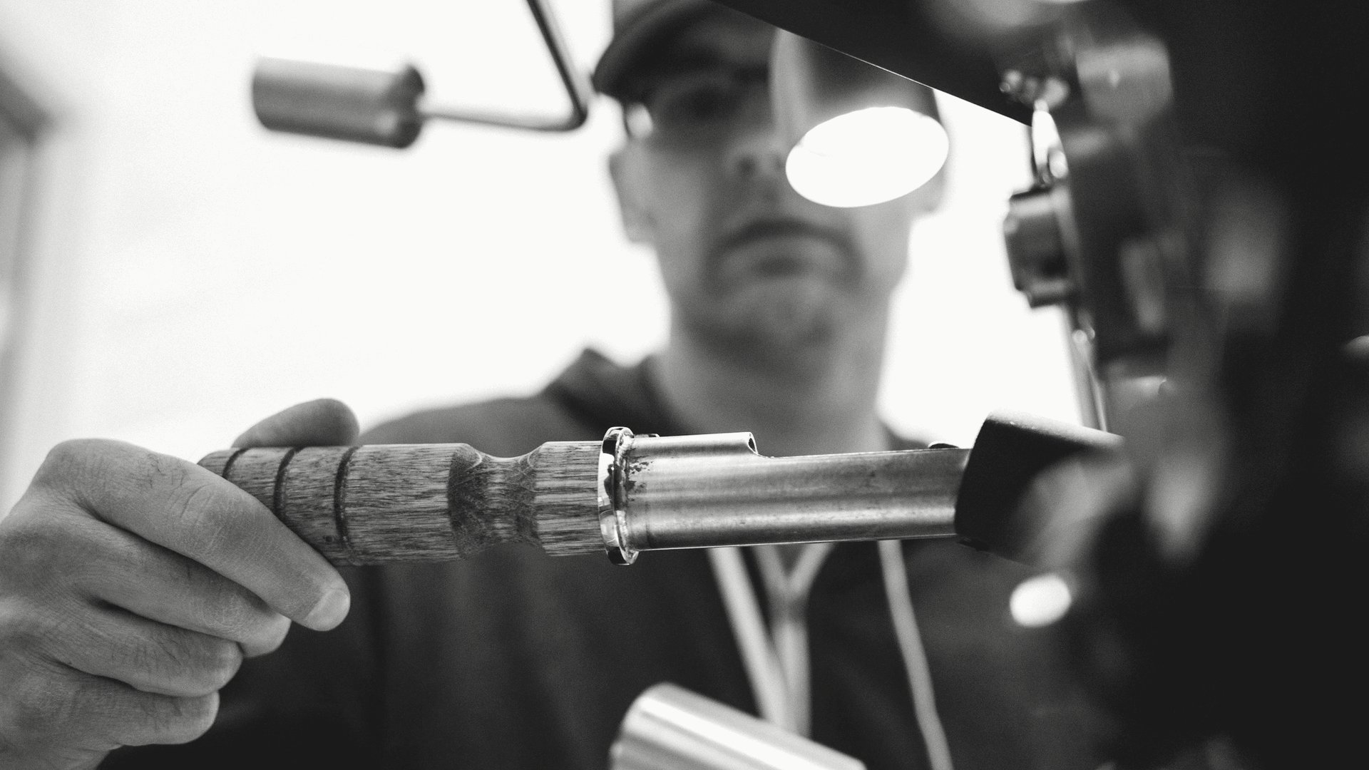 Weathered stucco and a rusted downspout bracket on a 1950s Mid-Wilshire courtyard building — visible signs of postponed envelope maintenance.